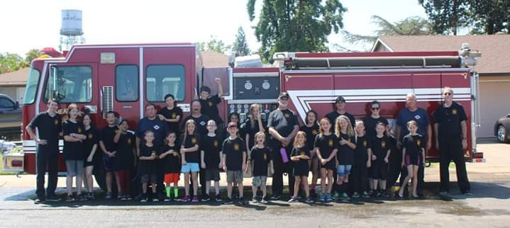 May contain: people, person, transportation, vehicle, fire truck, truck, and fire station