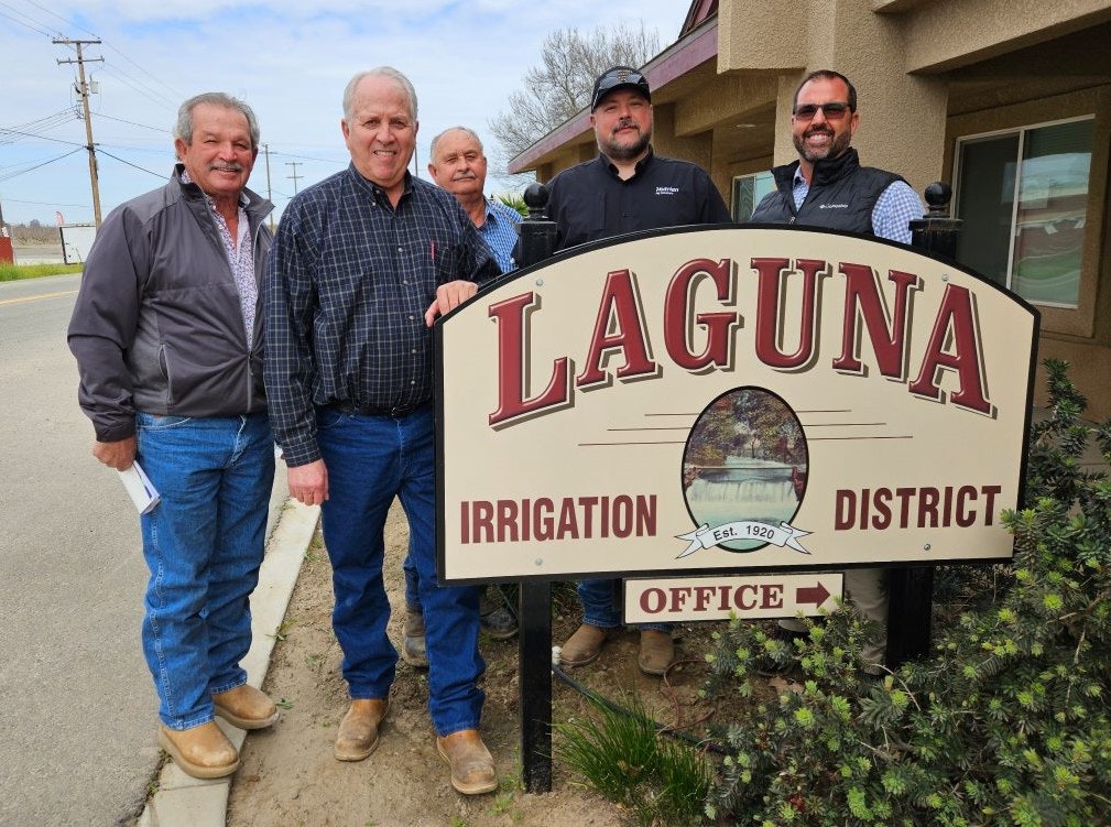 5 District Board Members standing by the District's Office Sign in front of the Office.