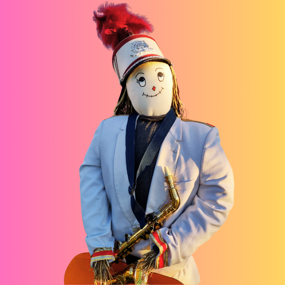 A scarecrow dressed as a band leader, holding a saxophone, on a pink-to-orange gradient background.