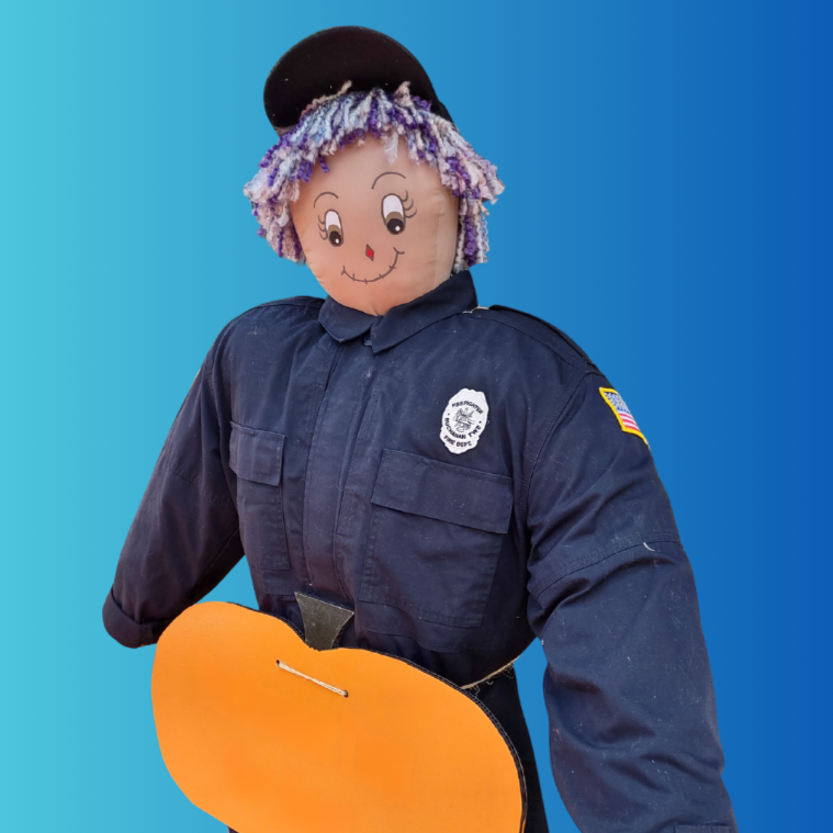 A mannequin dressed as a police officer, with a smiling face, purple hair, and holding a large orange shape.