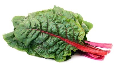 A bunch of green leafy Swiss chard with red stalks.