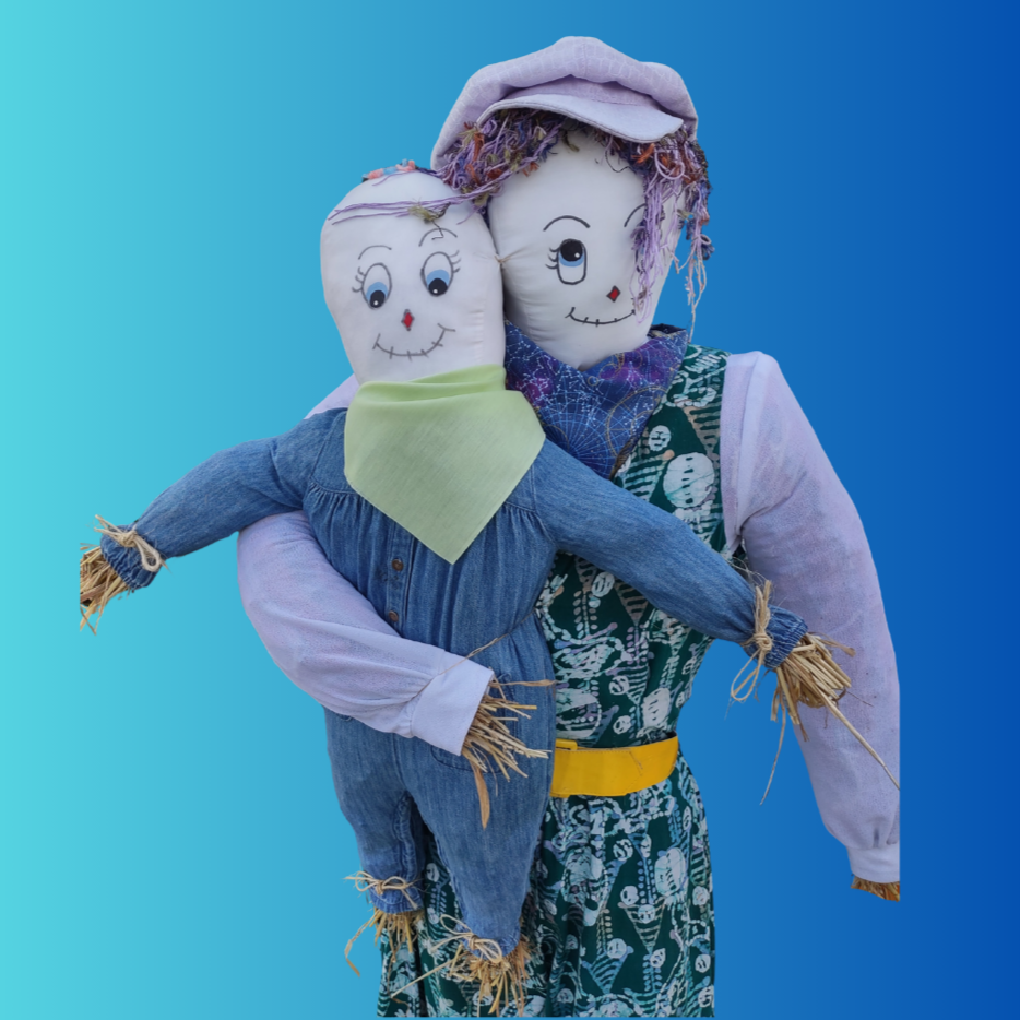 Two scarecrows dressed in colorful clothing, one holding the other, against a blue gradient background.