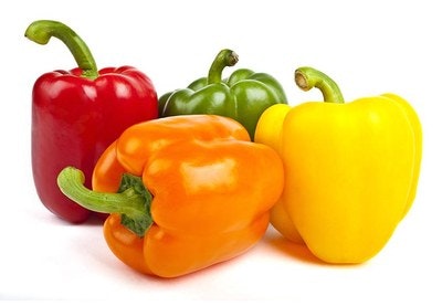 Four bell peppers in red, green, orange, and yellow.