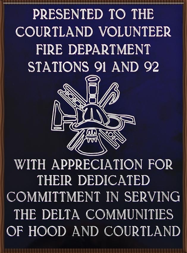 Plaque honoring Courtland Volunteer Fire Department Stations 91 and 92 for dedicated service to Delta communities.