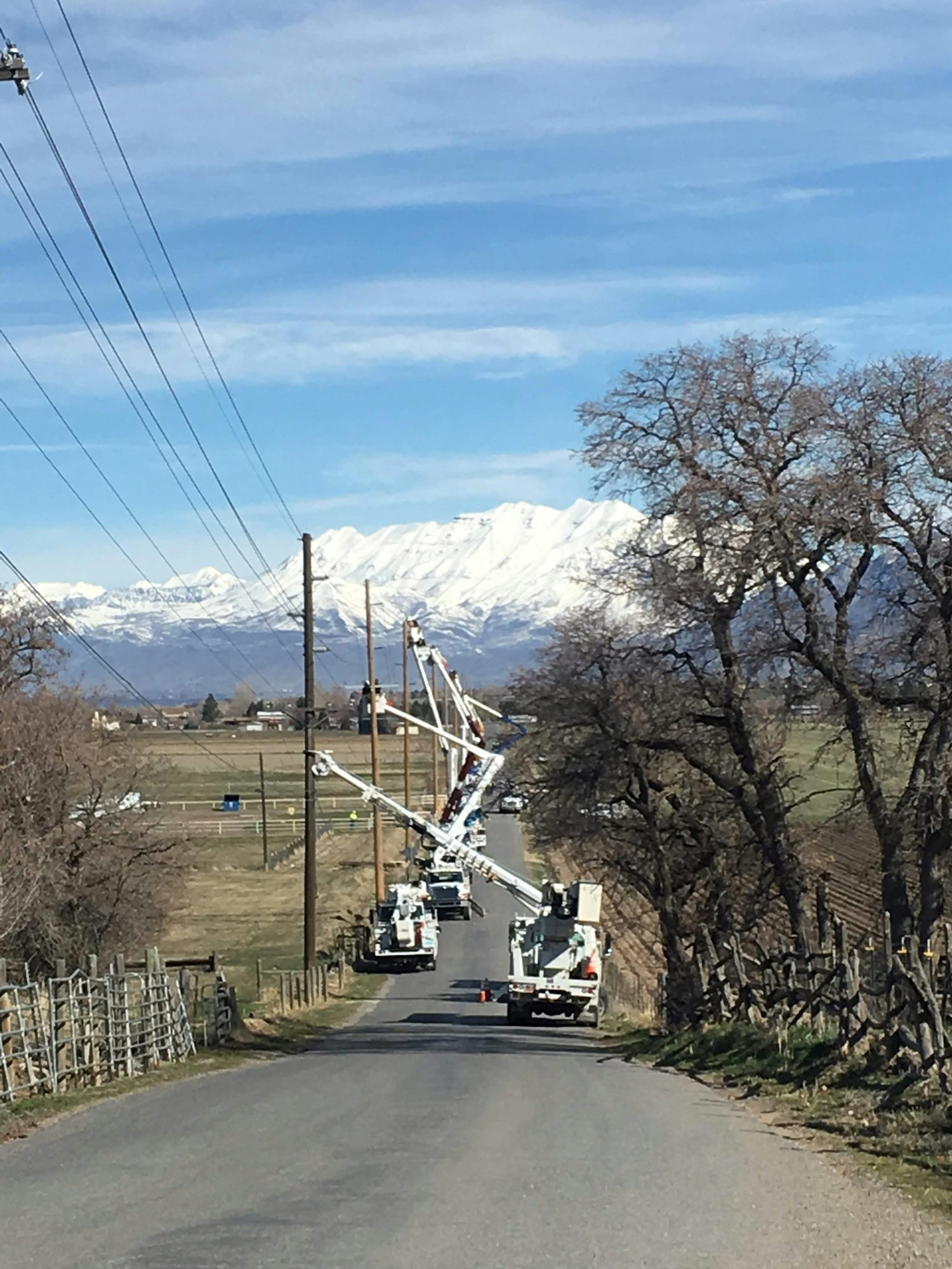 May contain: cable, power lines, and electric transmission tower