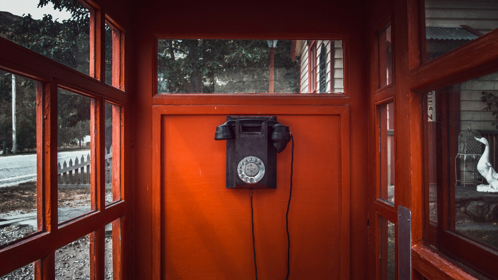 old phone in red phone booth