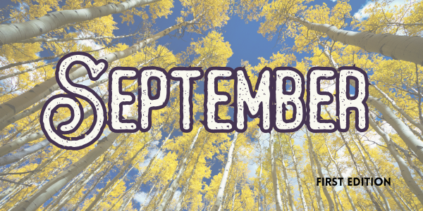 The image shows the word "September" over a sky view of tall yellow-leaved trees. It says "First Edition" in the corner.