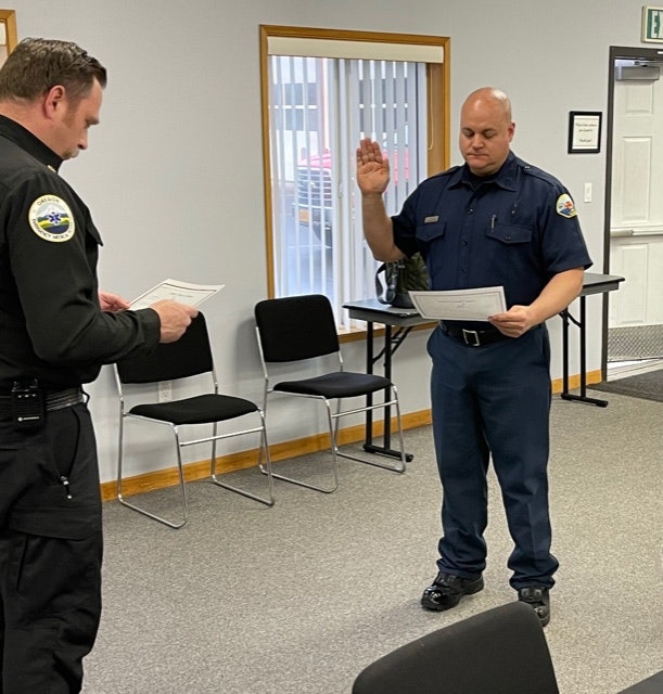 May contain: chair, furniture, person, human, military, military uniform, officer, guard, shoe, clothing, footwear, apparel, and police