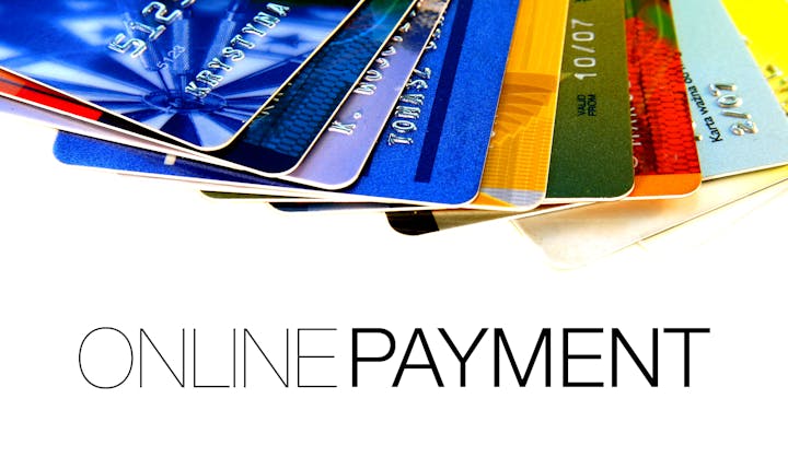 The image features multiple credit cards stacked together and the text "ONLINE PAYMENT" prominently displayed.