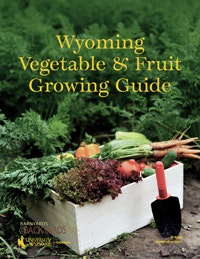 Cover of "Wyoming Vegetable & Fruit Growing Guide" with a box of vegetables and a garden trowel.