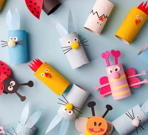 Crafty toilet paper rolls transformed into cute animals and insects with colorful paper and googly eyes.