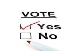 A voting paper with options "Yes" and "No," where "Yes" is checked. A pen is poised to mark the response.