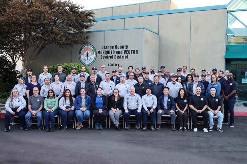 A group photo of staff in front of the Orange County Mosquito and Vector Control District building.