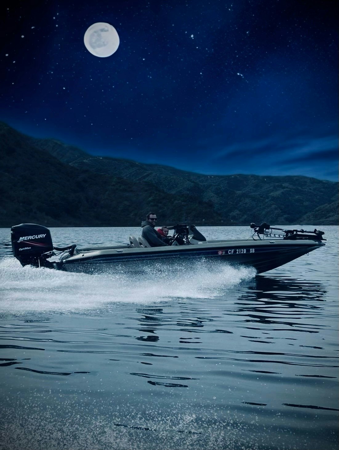 A person steering a speedboat on the water at night with a full moon and stars overhead.
