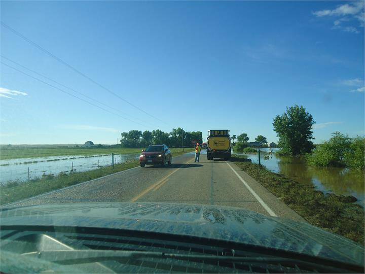 May contain: road, transportation, truck, vehicle, person, car, water, outdoors, freeway, and highway