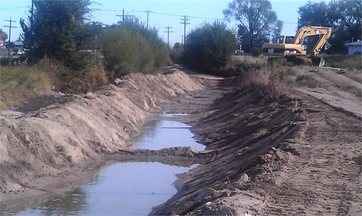 May contain: soil, outdoors, ditch, bulldozer, machine, water, and nature