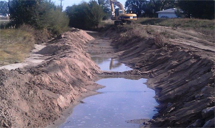 May contain: soil, outdoors, nature, ditch, bulldozer, machine, and water