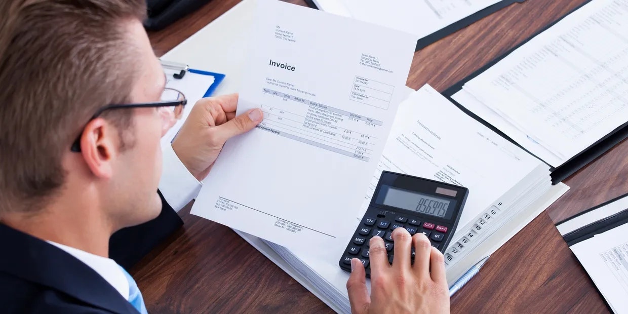 Man using a calculator