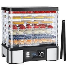 A food dehydrator with multiple trays filled with sliced fruits, featuring a digital display and control knob.