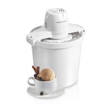 White ice cream maker with a cup of ice cream in front.