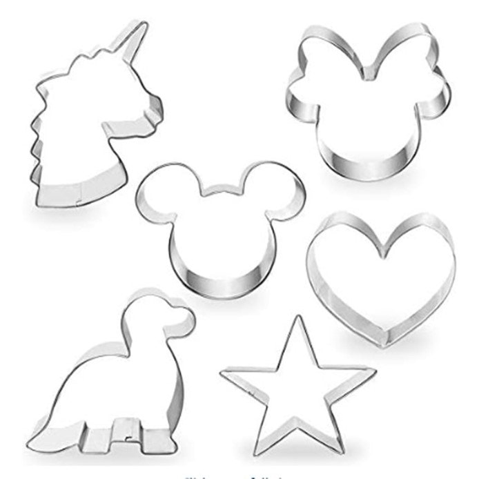Various metal cookie cutters: unicorn, butterfly, mouse ears, heart, dinosaur, and star shapes.