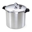 A stainless steel pressure cooker with a lid, pressure gauge, and black handles.