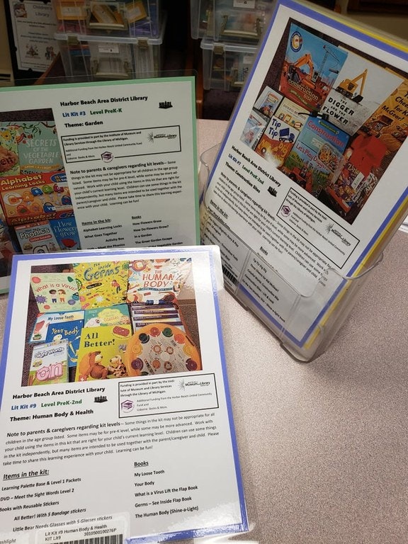 Library kits with themes: Garden, Construction, and Human Body & Health, displayed on a table.