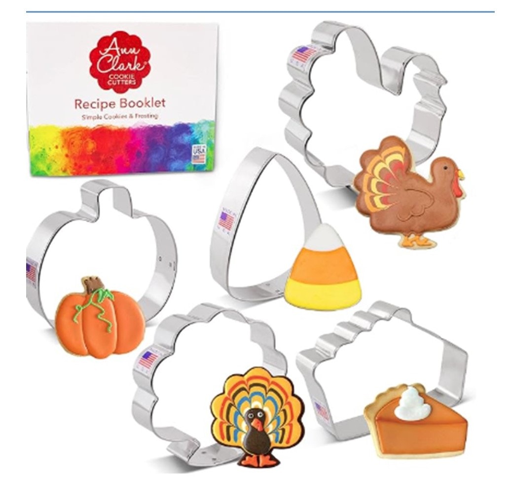 Cookie cutters shaped like a pumpkin, turkey, candy corn, with matching decorated cookies and a recipe booklet.
