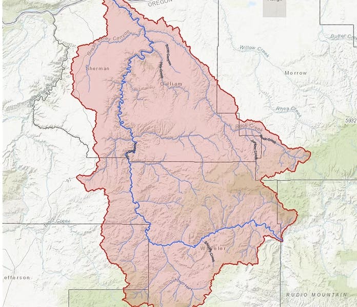 Map showing the John Day River Basin in Oregon, marked in pink with major rivers in blue, and county outlines.
