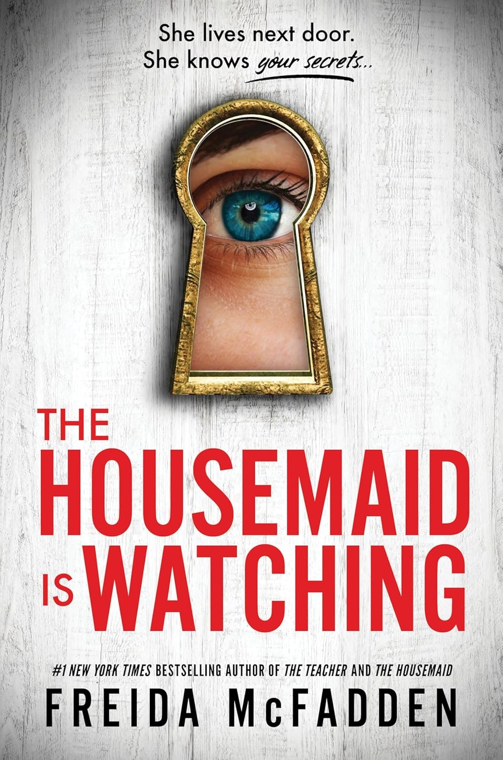 Book cover: "The Housemaid Is Watching" by Freida McFadden, with an eye visible through a keyhole.