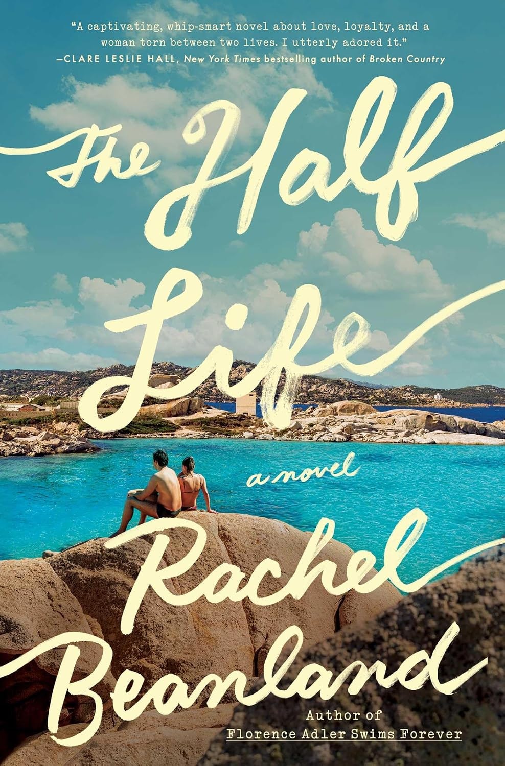 The image features the book cover of "The Half Life" by Rachel Beanland, showcasing a couple by a blue sea and scenic rocks.