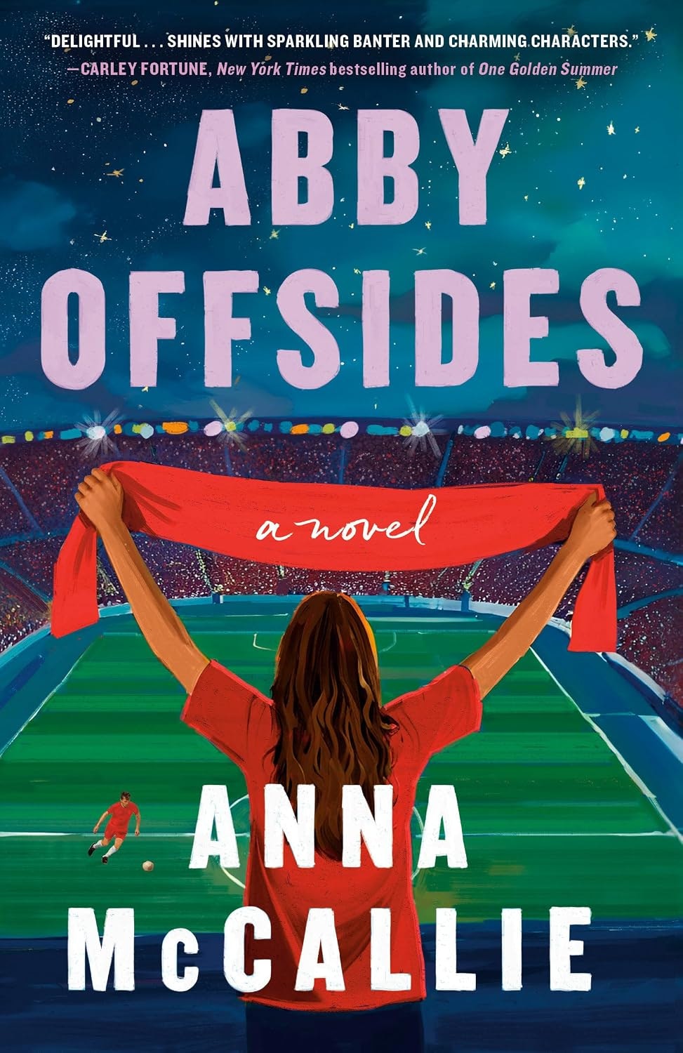 The image features the book cover for "Abby Offsides" by Anna McCallie, depicting a woman cheering at a soccer stadium.