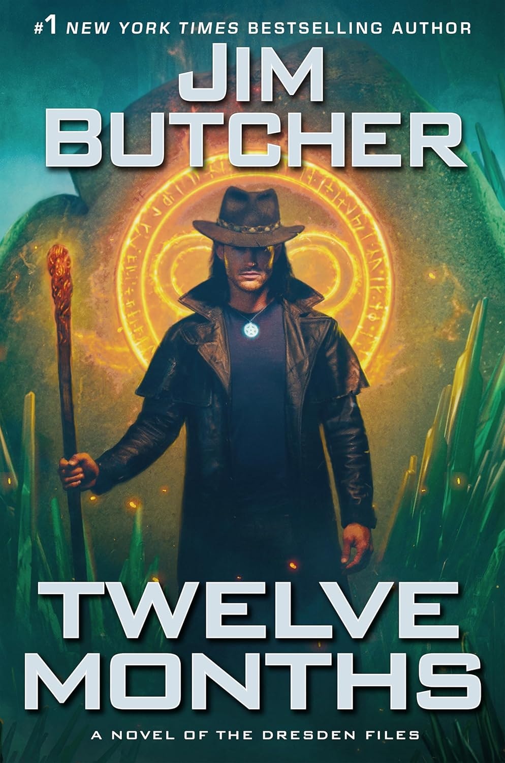 The image shows the cover of "Twelve Months" by Jim Butcher, featuring a mysterious figure with a staff and magical symbols.