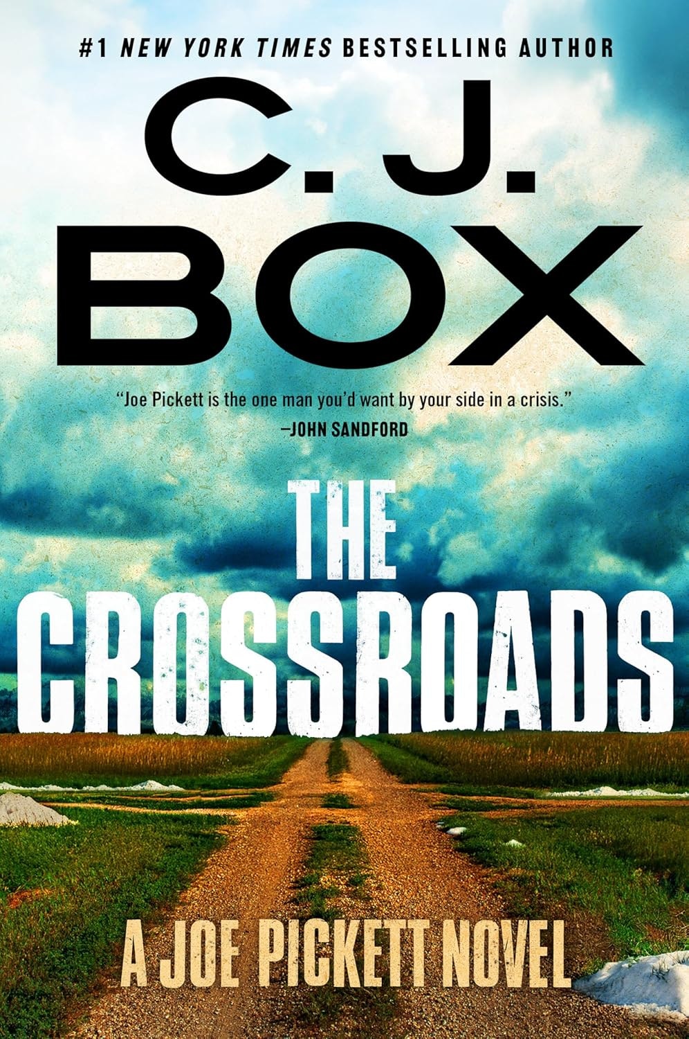 The image features the book cover for "The Crossroads" by C.J. Box, showcasing a rural landscape and themes of crisis.