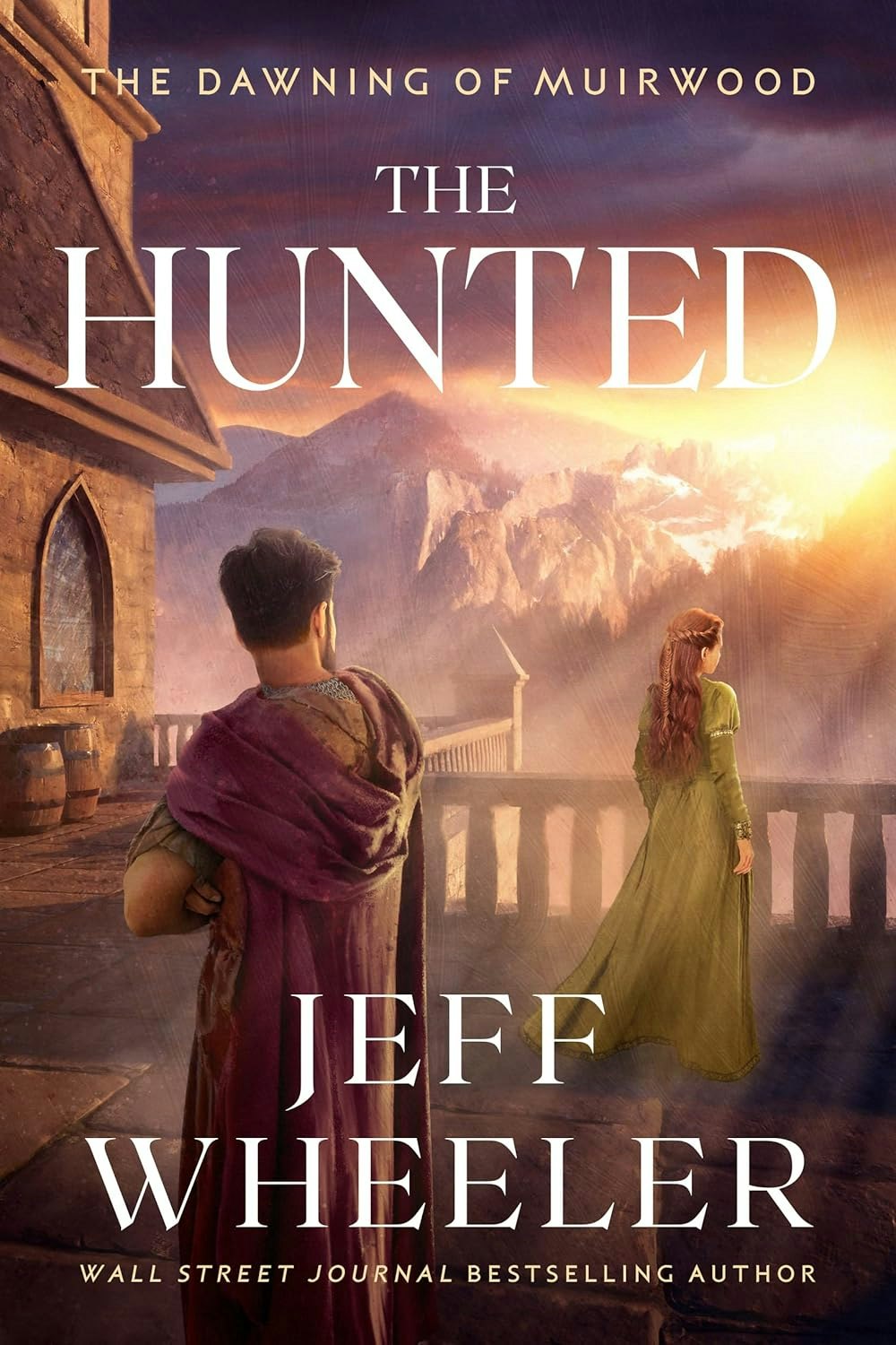 Book cover: "The Hunted" by Jeff Wheeler, with two figures overlooking a mountainous landscape at sunrise or sunset.