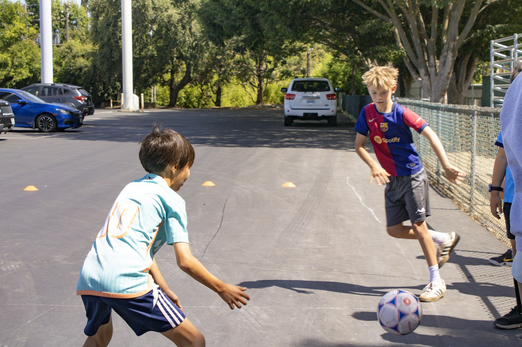 May contain: clothing, shorts, sphere, ball, football, soccer, soccer ball, sport, boy, child, male, person, people, footwear, shoe, car, transportation, vehicle, machine, and wheel
