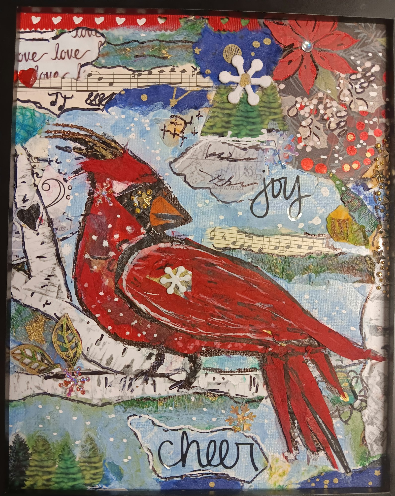 A vibrant artwork featuring a red cardinal amidst a winter scene, with words like "joy" and "cheer" and decorative details.