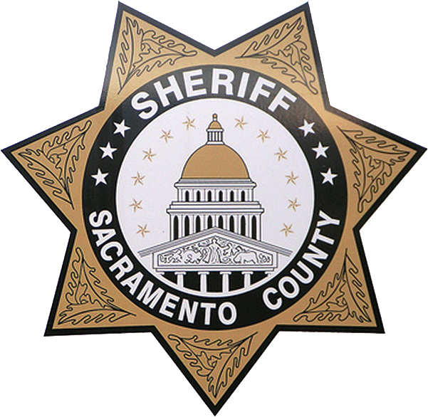 Sheriff badge for Sacramento County with a gold border and a building in the center.