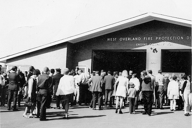 A crowd gathers at the West Overland Fire Protection District, Engine Company No. 1 building.