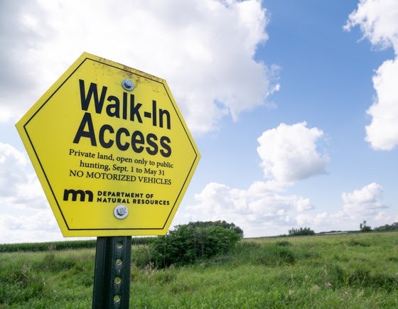 A yellow sign indicates "Walk-In Access" for private land, allowing public hunting from September to May, with no motorized vehicles.