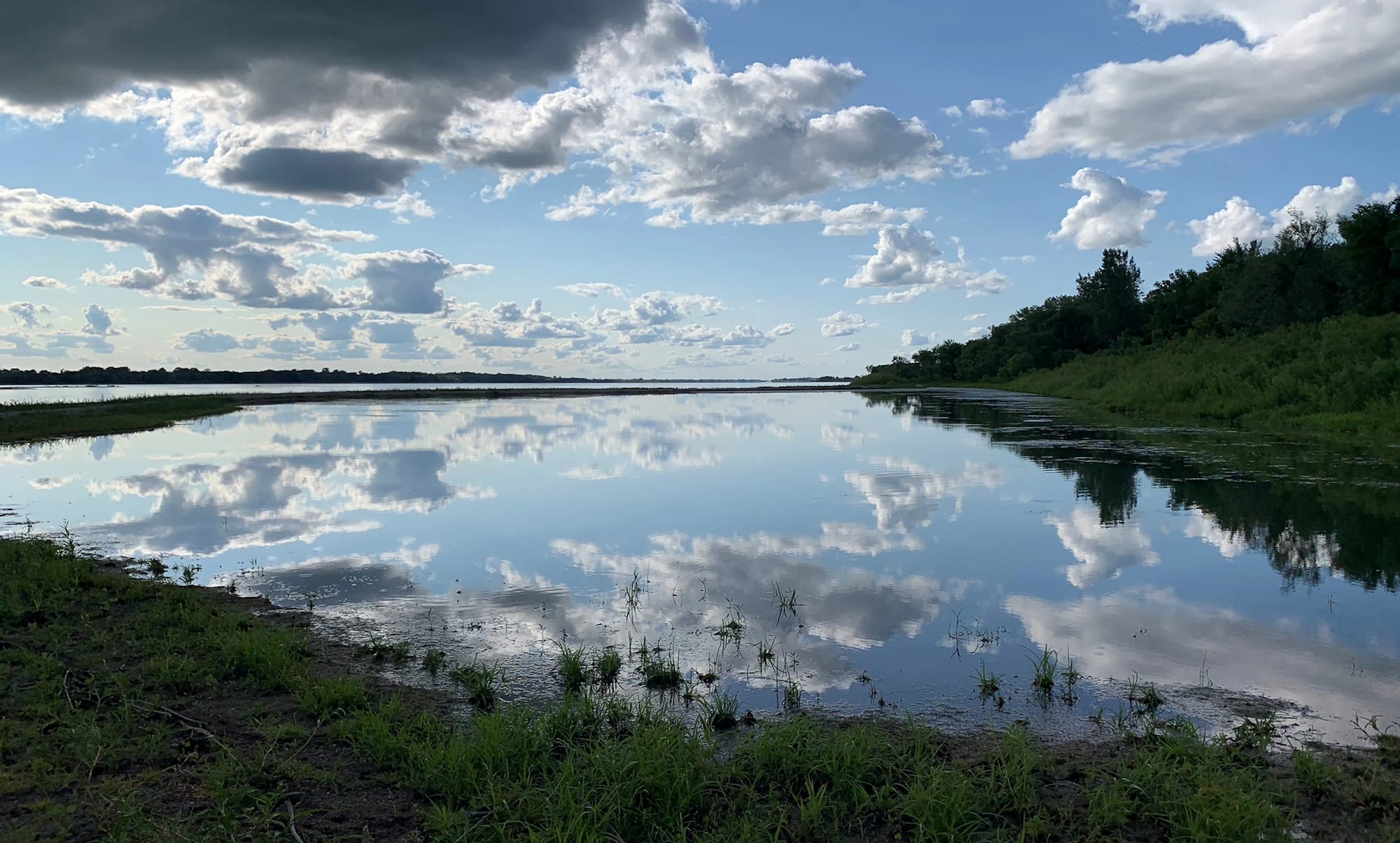 May contain: nature, outdoors, sky, cloud, cumulus, weather, land, scenery, pond, water, lake, and swamp