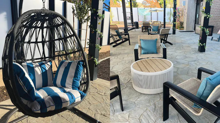 The image features a cozy outdoor seating area with a hanging chair and stylish furniture, accented by blue cushions and greenery.