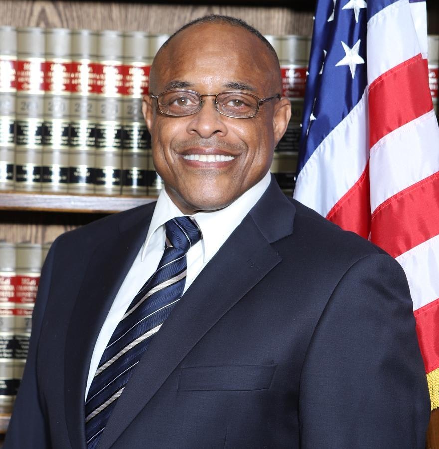 May contain: accessories, formal wear, tie, clothing, suit, adult, male, man, person, american flag, flag, blazer, coat, jacket, face, head, and glasses