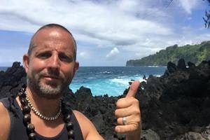 May contain: body part, finger, hand, person, photography, adult, male, man, rock, accessories, jewelry, necklace, face, head, selfie, portrait, and thumbs up
