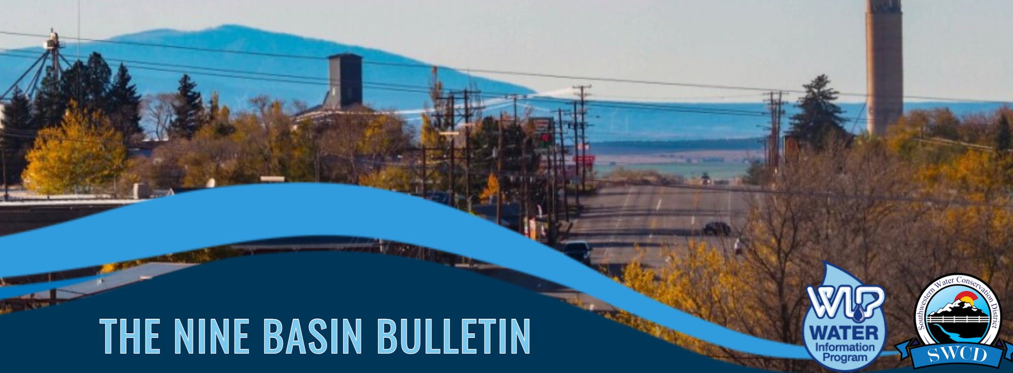 A landscape with industrial buildings, a clear sky, and text overlay for "The Nine Basin Bulletin".