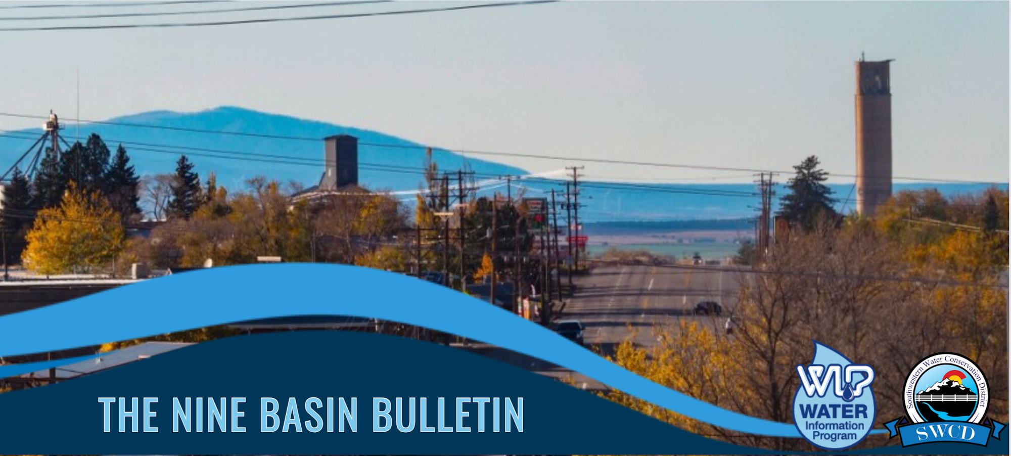 A landscape with industrial buildings, a clear sky, and text overlay for "The Nine Basin Bulletin".