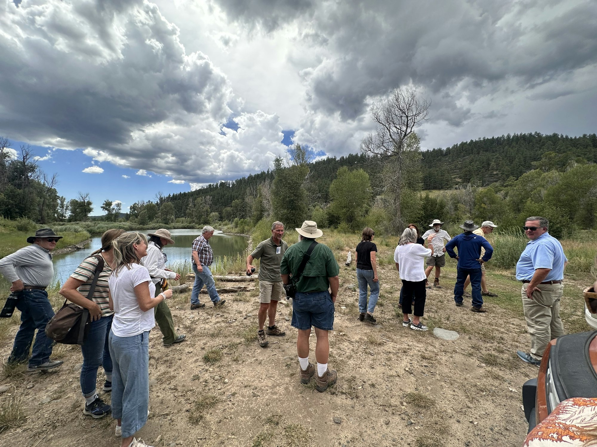 A group of individuals stand by the San Juan River.