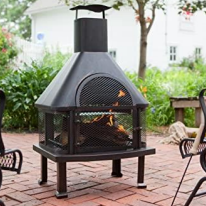 A patio with an outdoor fireplace and seating.