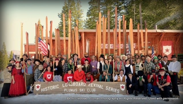 A large group dressed in vintage attire poses at the Plumas Ski Club for the Historic Logboard Revival Series.