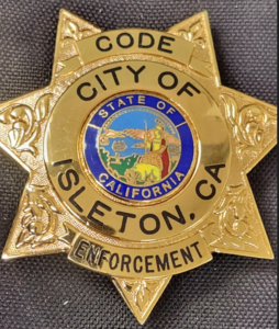 A City of Isleton, CA, Code Enforcement badge with California State seal.